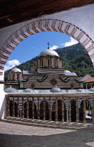 Nativity Church from balcony through arch  Rila Monastery.TravelTourismHolidayVacationExploreRecreationLeisureSightseeingTouristAttractionTourHistoryHistoricHistoricalNativityChurchRe...