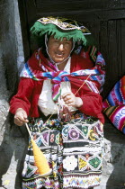 Lady wearing colourful traditional costume  spinning wool.Colorful Cuzco TravelTourismHolidayVacationExploreRecreationLeisureSightseeingTouristAttractionTourDestinationCuscoCuzcoPeruPe...