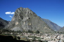 Pinkuylluna Mountain and town of Ollantaytambo  Sacred Valley of the Incas.Cuzco TravelTourismHolidayVacationExploreRecreationLeisureSightseeingTouristAttractionTourDestinationOllantaytamboOllantaitamboCuscoCuzcoPeruPeruvianSouthSouthernAmericaBlueSkyCultureCulturalTranquilTranquilityBuildingsEthnicSacredValleyOfTheIncaIncasInkaInkasCommunityHillHillsidePinkuyllunaMountainMountainousOverlookingOverlookScenicLandscapePanoramaPanoramicViewVistaPicturesqueRuralUrbanTownTownshipHousesHousingHomesResidenceAbodeDwellingsCrampedCompactSprawlSprawlingInvasiveBlightBlightedPlanningDevelopingDevelopmentProgressSpreadingOverspillBackdropBackgroundInterestOverpopulatedPopulatedDominantDominatingProminentLlactaUrubambaAndesAndeanCalendarAmerican South America