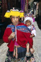 Young girl with her sister on her back  Pisac Market.Cuzco Pisaq TravelTourismHolidayVacationExploreRecreationLeisureSightseeingTouristAttractionTourDestinationPisacCuscoCuzcoPeruPeru...