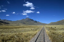 Railway track through the Andes mountain range  Puno to Cusco Perurail train journey.Cuzco TravelTourismHolidayVacationExploreRecreationLeisureSightseeingTouristAttractionTourDestinationP...