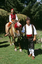 Man and girl in national costume with horse  Pirin Mountain  near Bansko.Equestrian TravelTourismHolidayVacationAdventureExploreRecreationLeisureSightseeingTouristAttractionTourChalinVal...