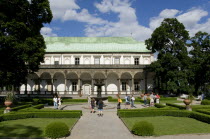 Tourists in the gardens around the Singing Fountain in front of the Belvedere or Royal Summer Palace in the Italian Renaissance style built by King Ferdinand I for his wife AnnePraha Ceska Eastern Eu...