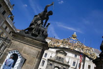 Sentry beside Guardbox under 18th century statues of fighting Giants by Ignaz Platzer at the entrance to Prague Castle Praha Ceska Eastern Europe European