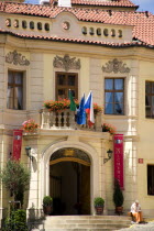 Woman sitting on the steps up to the Residence Hotel de Charme in the Little QuarterPraha Ceska Eastern Europe European