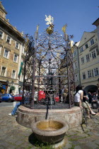 Old Town.Tourists around a water fountain with ornate metalwork in Male NamestiPraha Ceska Eastern Europe European