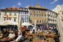 Old Town. People sitting at tables with umbrellas at street cafe in Male NamestiPraha Ceska Eastern Europe European Bar Bistro Restaurant
