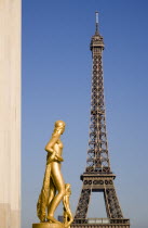 Gilded bronze statues of women in the central square of the Palais Chaillot with the Eiffel Tower beyondEuropean French Western Europe