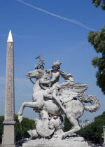 Equestrian stone statue in the Jardin des Tuileries with the Obelisk in the Place de la Concorde beyondEuropean French Western Europe