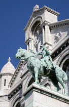 Montmartre The statue of Christ in the centre of the facade of the church of Sacre Couer with the bronze equestrian statue of Joan of Arc belowCenter European French Religion Western Europe