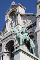 Montmartre The statue of Christ in the centre of the facade of the church of Sacre Couer with the bronze equestrian statue of Joan of Arc belowCenter European French Religion Western Europe