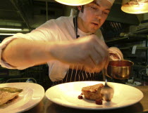 Chef Plating Up Fillet Steak and Raspberry CoulisFood  cooking Great Britain UK United Kingdom British Isles Northern Europe