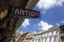 Renaissance and Baroque houses in Bridge Street in the Little Quarter with an Antiques shop sign hanging above the pavementPraha Ceska Eastern Europe European Store
