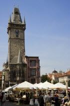 Cafe and restaurant tables under umbrellas in the Old Town Square beside the Old Town Hall Clock TowerPraha Bar Bistro Ceska Eastern Europe European