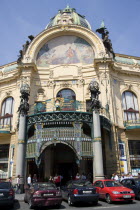 Parked cars and pedestrians outside The Art Nouveau Municipal House entrance in The Old Town with the mosaic by Karel Spillar titled Homage To Prague under the Hall domePraha Asian Ceska Eastern Europe European