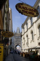 Karlova Street lined with food stalls leading to the Old Town Bridge Tower on the Charles Bridge. An overhead sign advertises traditional Black Light TheatrePraha Ceska Eastern Europe European Theate...