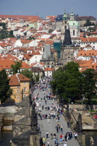 People walking on The Charles Bridge across the Vltava River leading to the Little Quarter.Praha Ceska Eastern Europe European