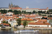 A cruise boat on the Vltava River passes the Little Quarter below St Vituss Cathedral and Prague Castle in HradcanyPraha Ceska Eastern Europe European Religion