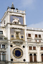 The 15th Century Torre dellOrogolio  Clock Tower  with the two bronze Mori or Moors at the top who strike the bell on the hour. Below is the winged Lion of St Mark  the Madonna  and the ornate clock f...