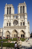 Tourists in the Place du Parvis Notre Dame in front of the Gothic medieval Notre Dame Cathedral on Ile De La CiteEuropean French Religion Western Europe