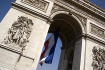 The Arc de Triomphe in Place Charles de Gaulle with a large French Triclour flag hanging from the central arch.European Western Europe