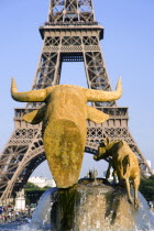 Gilded bronze sculpture of a cow and her calf in the Trocadero Fountains with the Eiffel Tower in the distanceEuropean French Western Europe