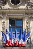 French Tricolour flags displayed on a window balcony of the Musee du LouvreEuropean Western Europe
