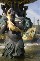 Ornate figures in a 19th Century fountain in the Place de la Concorde with the Eiffel Tower in the distanceEuropean French Western Europe