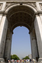 The central arch of the Arc de Triomphe in Place Charles de Gaulle filled with tourists.European French Western Europe