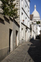 Montmartre The Church of Sacre Couer seen at the end of a narrow streetEuropean French Religion Western Europe