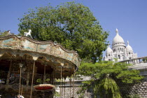 Montmartre A funfair carrousel at the base of the hill leading up to the Church of Sacre CouerEuropean French Religion Western Europe