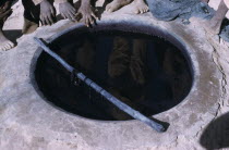 Indigo dye pit reflecting workers.