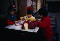 Children doing homework outside house.Asia Asian Chinese Chungkuo Jhonggu Kids Learning Lessons Teaching Zhonggu  Asia Asian Chinese Chungkuo Jhonggu Kids Learning Lessons Teaching Zhonggu