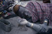 Dinka man having his hair dyed using cattle urine.African Middle East North Africa Sudanese  African Middle East North Africa Sudanese