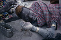Dinka man having his hair dyed using cattle urine.African Middle East North Africa Sudanese  African Middle East North Africa Sudanese