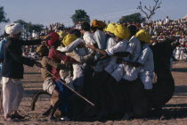 Competition at camel fair to fit as many as possible on to a camel.Asia Asian Bharat Inde Indian Intiya  Asia Asian Bharat Inde Indian Intiya