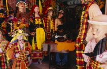 Costume maker for Oruro Carnival. Man working on sewing machine  surrounded by mannequins.American Bolivian South America Hispanic Latin America Latino American Bolivian South America Hispanic Latin...