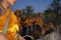 Novice Buddhist monks from The Golden Horse Forest Monastery  riding out to collect alms and preach the evils of amphetamines or Ya Ba. Thai/Burmese border. Asian Equestrian Kids Prathet Thai Raja An...