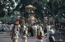 Esala Perahera festival parade with decorated Maligawa Tusker elephant carrying replica of the golden relic casket  dancers and musicians.