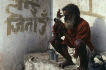 Saddhu applying his tika mark of blessing at the Pashupatinath Temple Maha Shivaratri festival celebrating the birth of Shiva.Asia Asian Nepalese Religion Religious Asia Asian Nepalese Religion Reli...