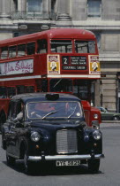 Black cab and red bus driving around Marble Arch European Great Britain Londres Northern Europe UK United Kingdom British Isles