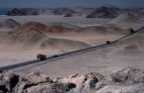 Car and buses on the Pan American highway through coastal desert area Automobile