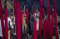 Kuan Yin Teng or Temple of Mercy with people carrying jos sticks and  praying in front of large jos sticksAsian Malaysian Religion Southeast Asia Religious Asian Malaysian Religion Southeast Asia Re...