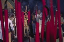 Kuan Yin Teng or Temple of Mercy with people carrying jos sticks and  praying in front of large jos sticksAsian Malaysian Religion Southeast Asia Religious Asian Malaysian Religion Southeast Asia Re...