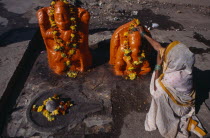 Woman making votive offerings at Ganesh shrine Asia Asian Bharat Inde Indian Intiya Religion Religious Asia Asian Bharat Inde Indian Intiya Religion Religious