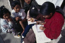 Children doing homework on street