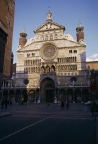Il Duomo exterior facade with people  children and pigeons in square in the foreground. Italia Italian Southern Europe cathedral European Kids Religion Religious
