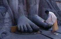 Jain Brahmin at feet of statue of Bahubali  the Gomateshvara.Asia Asian Bharat Inde Indian Intiya Religion Religious Asia Asian Bharat Inde Indian Intiya Religion Religious