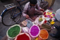 Man with brightly coloured powdered paints for use during the Holi Festival.Asia Asian Bharat Colored Inde Indian Intiya Religion Religious Asia Asian Bharat Colored Inde Indian Intiya Religion Reli...