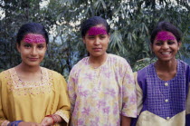 Three young women with coloured rice on their foreheads for Diwali.  Three-quarter portrait. Asia Asian Bharat Colored Inde Indian Intiya Religion Religious Asia Asian Bharat Colored Inde Indian Int...